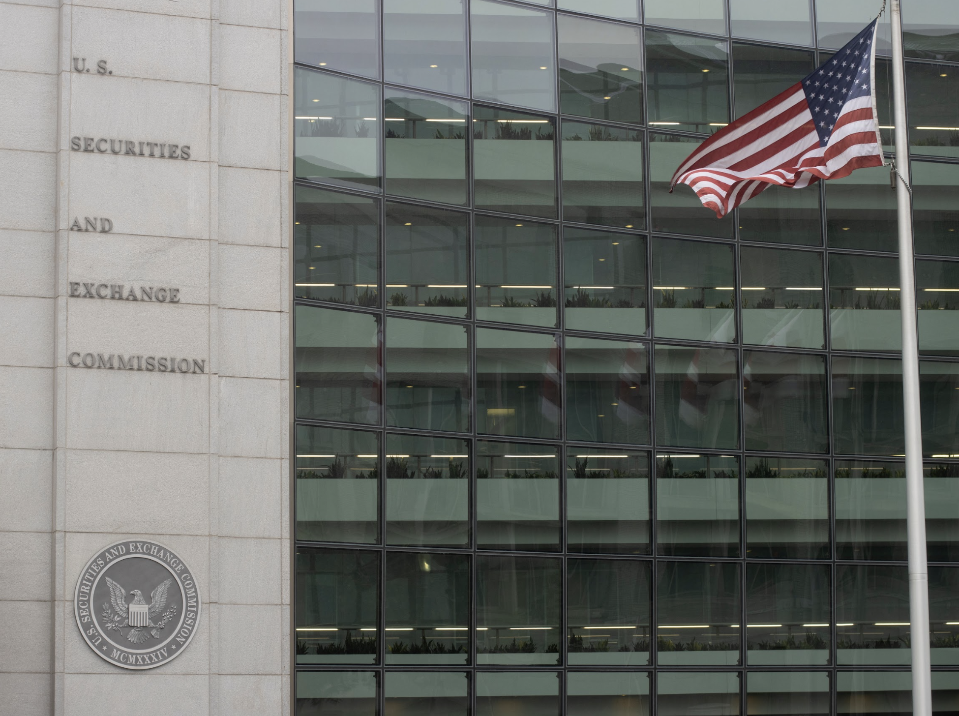 exterior photo of the US SEC building with a flag in front
