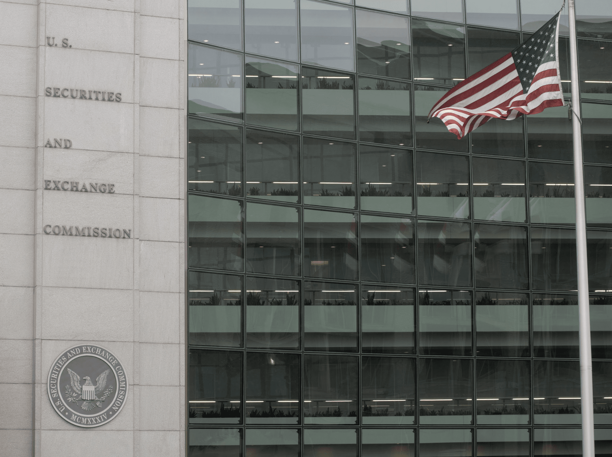 exterior photo of the US SEC building with a flag in front