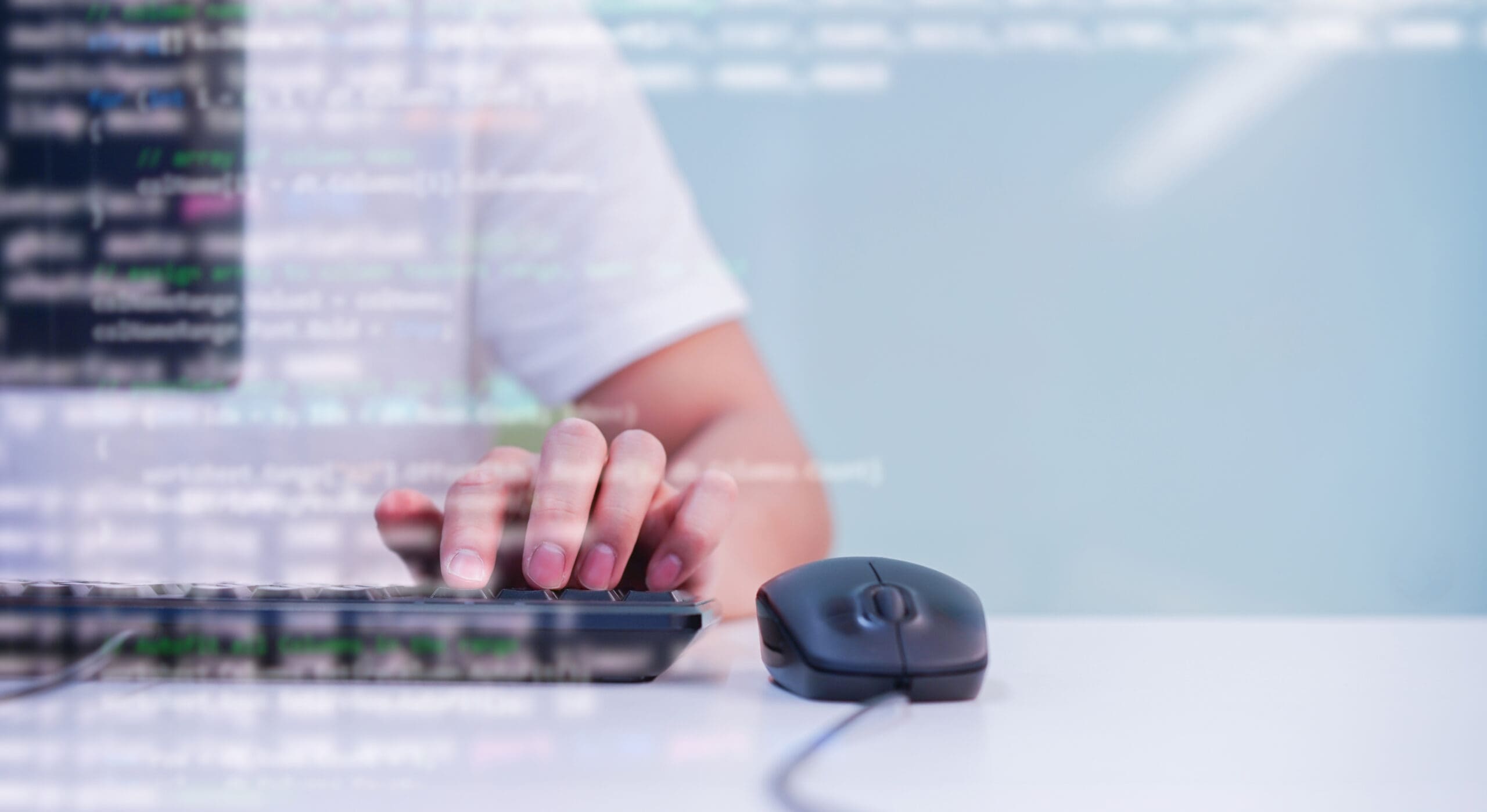 photo of person working at a computer with a semi-transparent overlay of code over top