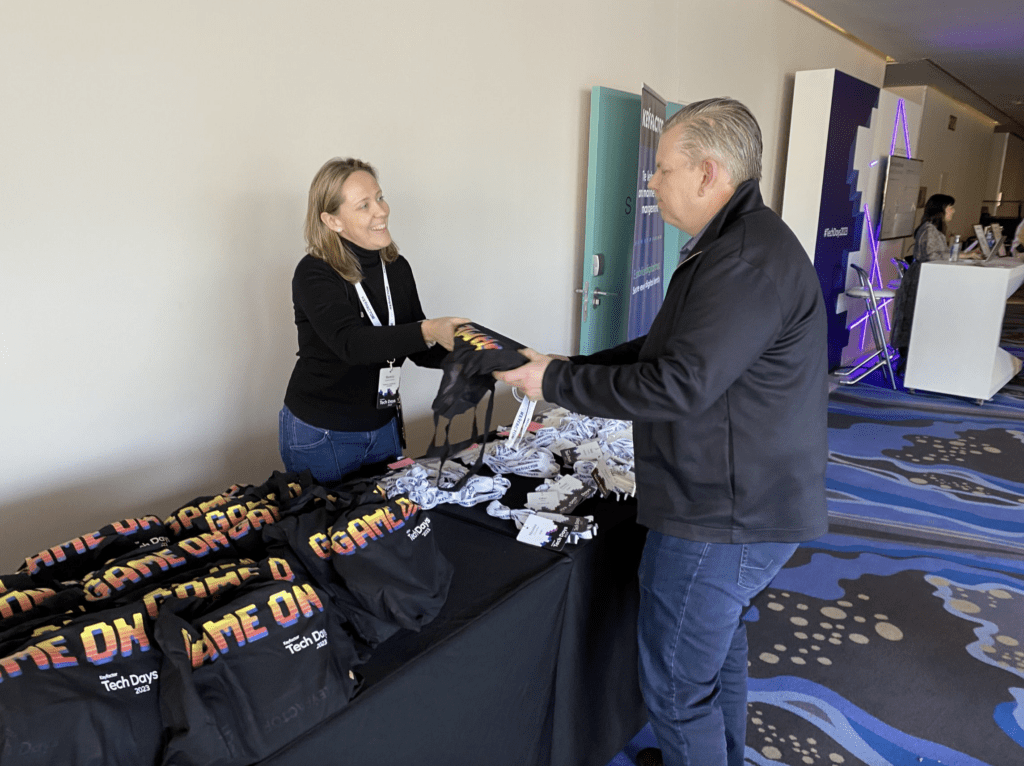 photo of Tech Days 2023 attendee getting swag bundle