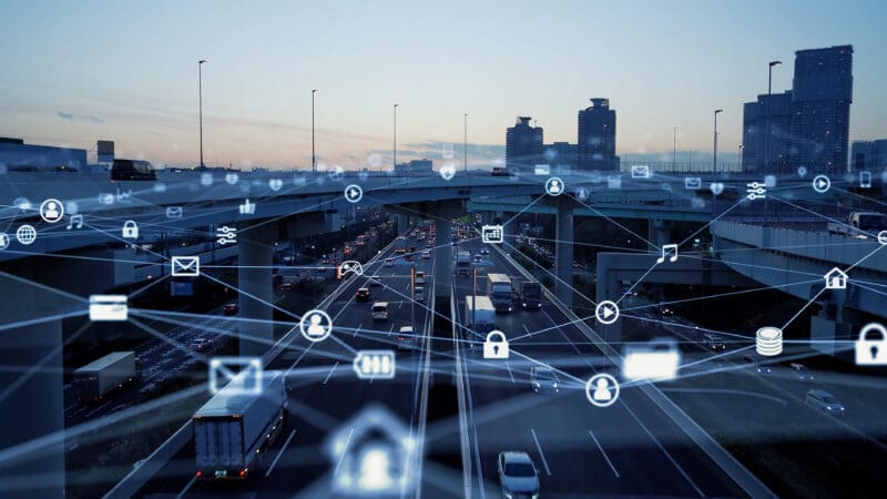 photo of busy highway with graphic illustration of connected devices